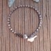 My favorite swarovski crystal bracelet , comfortable, washable, earthy, wear with anything, big sparkle and silver flower or bird
