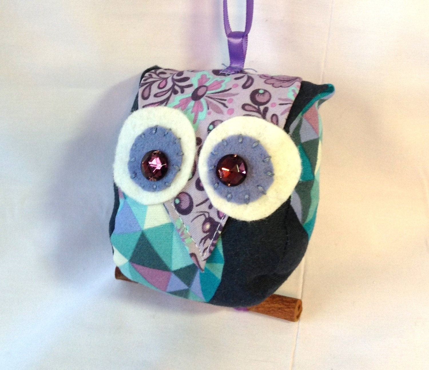 Small owl ornement in shades of lilac, navy and turqoise