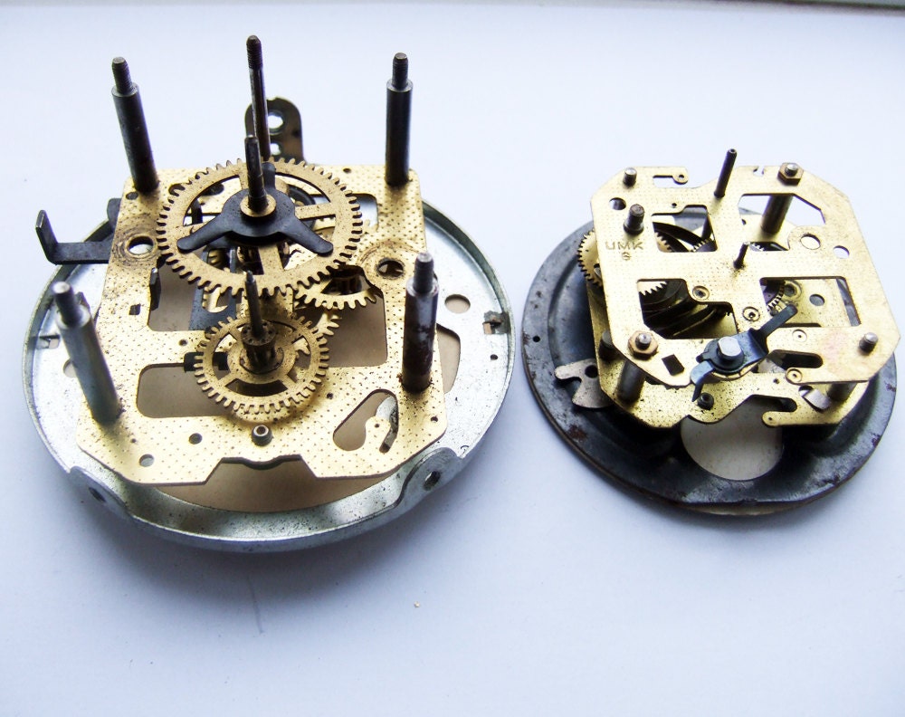 Two partial clock movements with faces