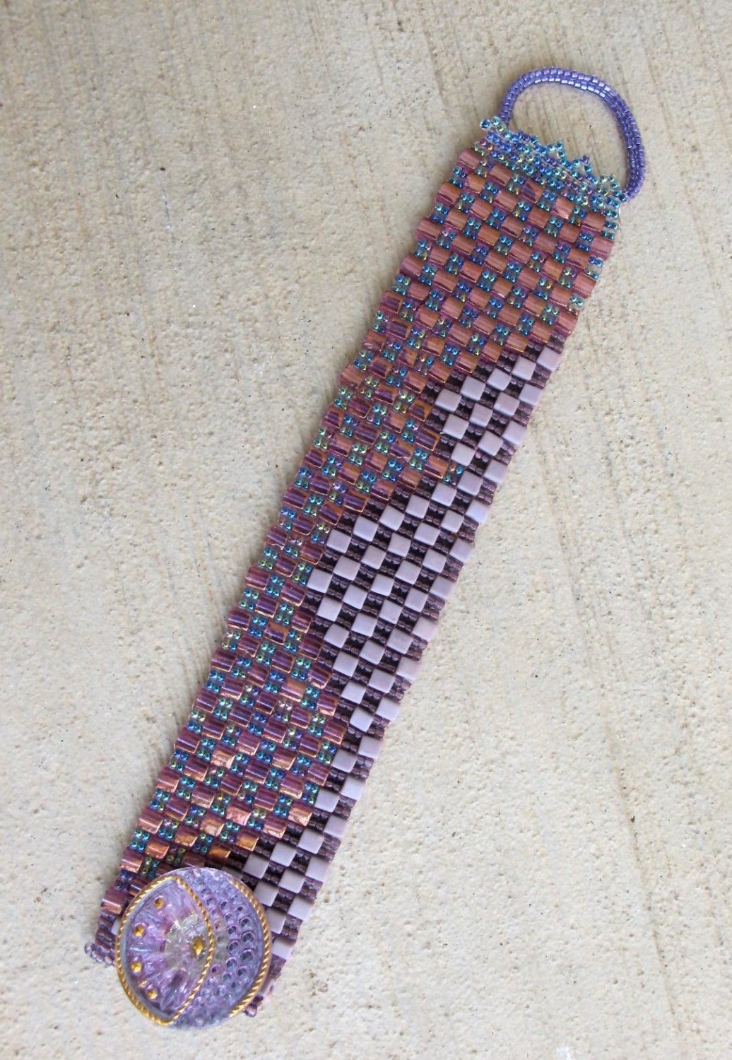 LAVENDER FIELDS Cubic Wave Cuff bracelet. In various tones of lavender and mauve and a bright cyrstal button. 7 1/2 inch long