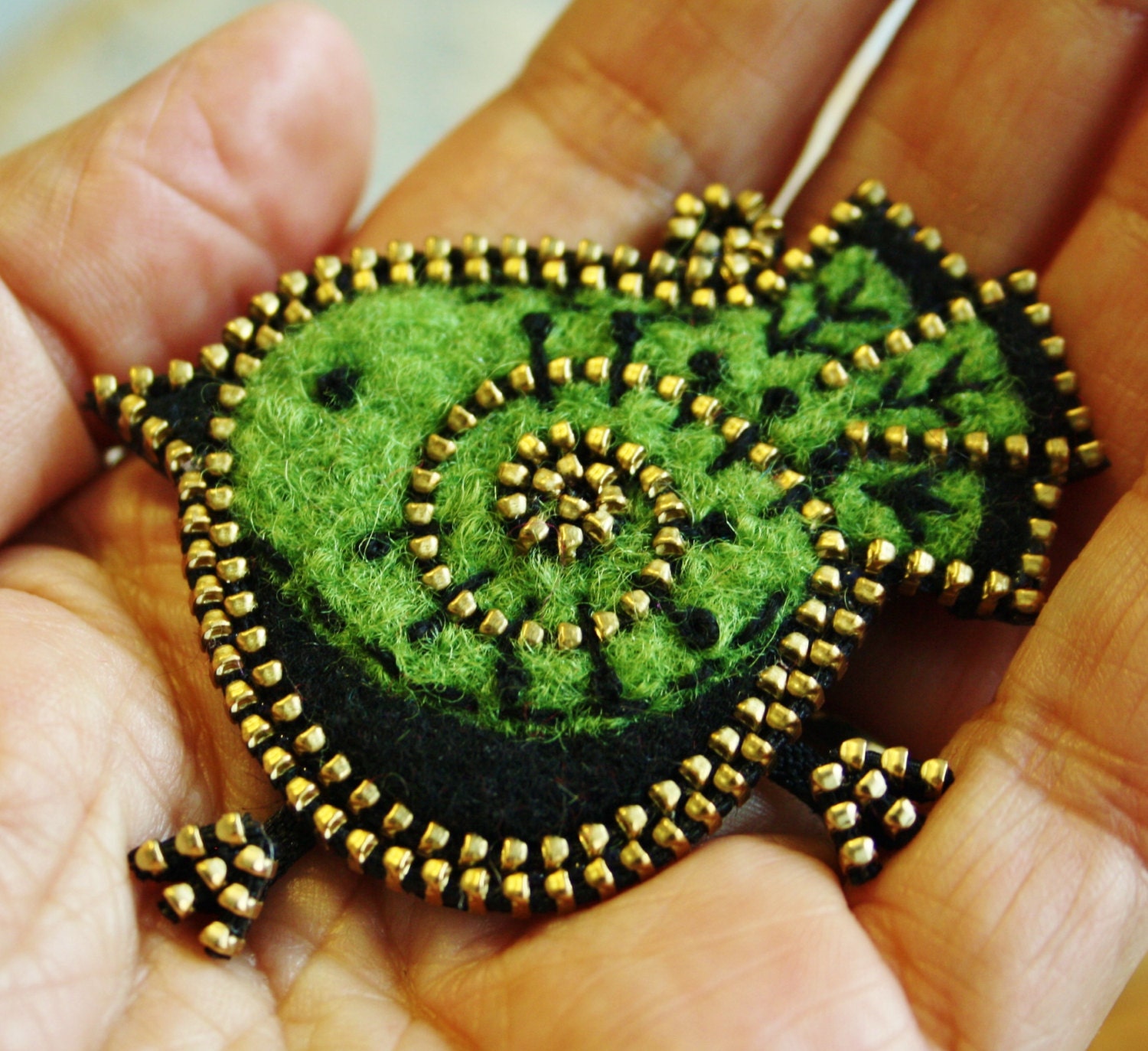 Bright green and black bird brooch
