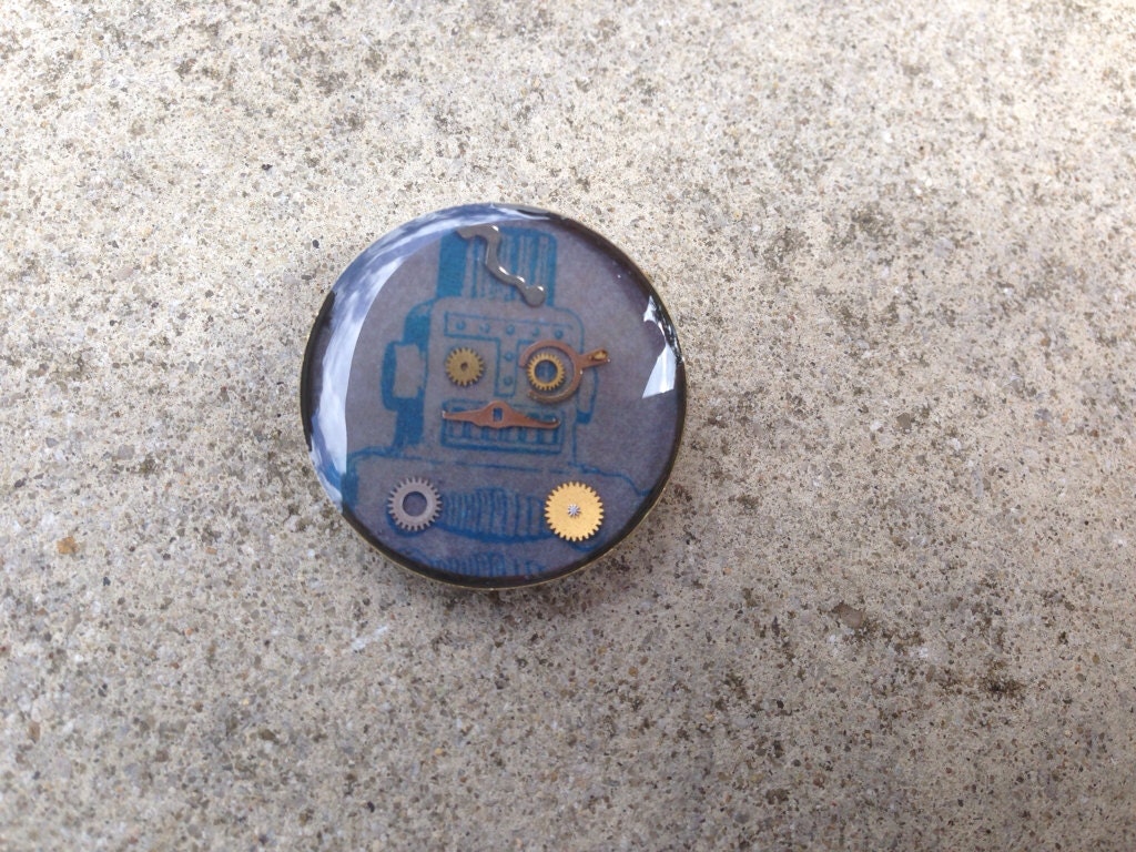 Blue robot with cogs badge