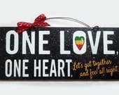 One Love One Heart sign. Reggae song lyric with glitter.