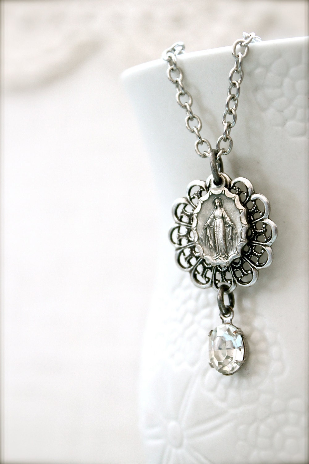 Antique silver Miraculous Medal necklace.  Vintage glass rhinestone and lacy filigree.  Religious keepsake.