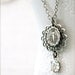 Antique silver Miraculous Medal necklace.  Vintage glass rhinestone and lacy filigree.  Religious keepsake.