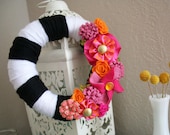 Bright and whimsical mini yarn wreath with hot pink and orange accents