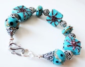 Blue green lampwork bracelet.  Teal glass bracelet.  Bali silver starfish bracelet.