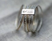 9 twist and turn silver with 14kt yellow gold stacking rings