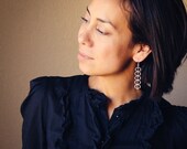 Sculptural silver earrings constructed of a series of curved wires in a meticulous yet almost musical arrangement - "Acoustic Earrings"