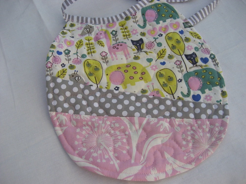 Quilted baby girl reversible bib with zoo animals and dandelions