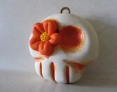 Skull ornament with orange flower