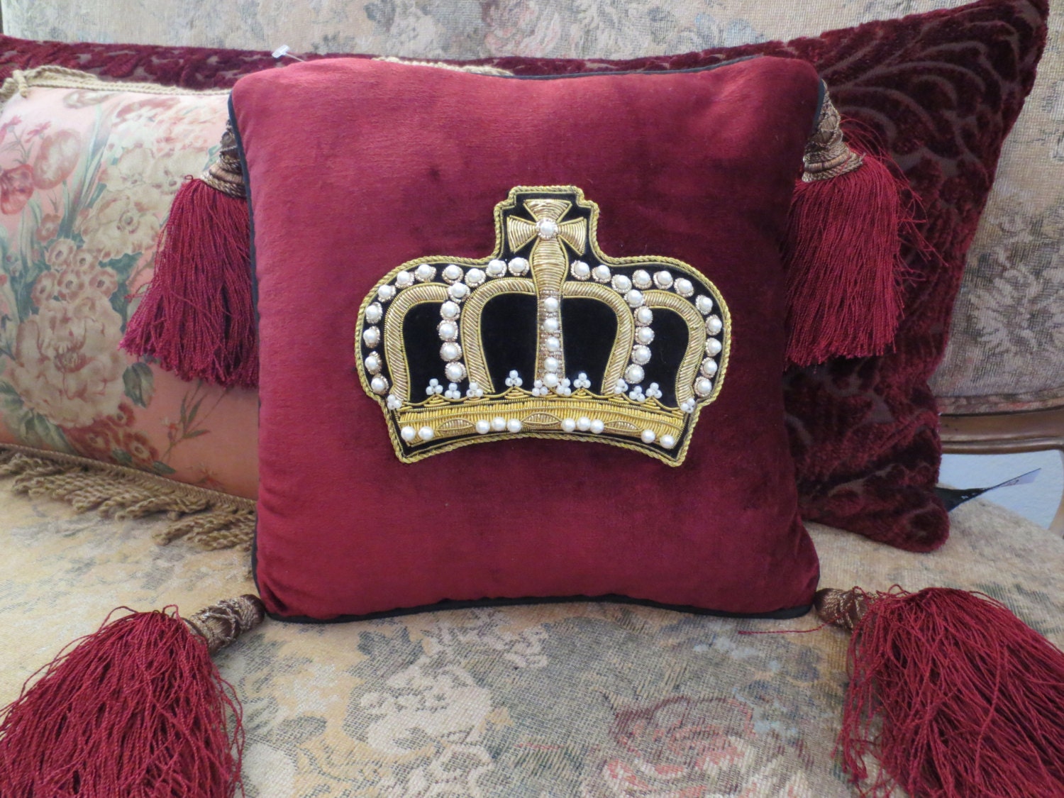 10 x 10 inch burgundy pearl embellished pillow.