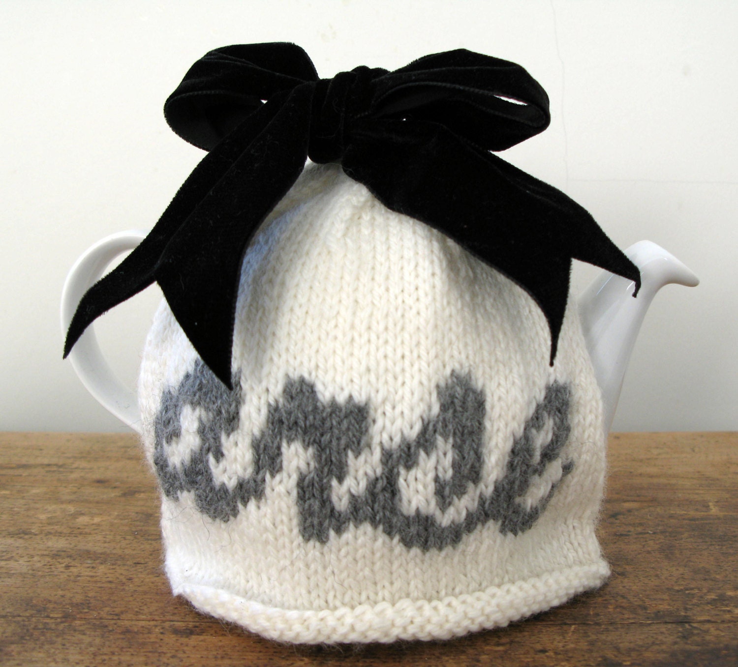 Rude "arse" cream and grey wool tea cosy