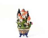 Miniature Alpine French Fairy Houses on the Hill  -  Blue Porcelain Vessel with Mushrooms and Dark Green Pine Trees