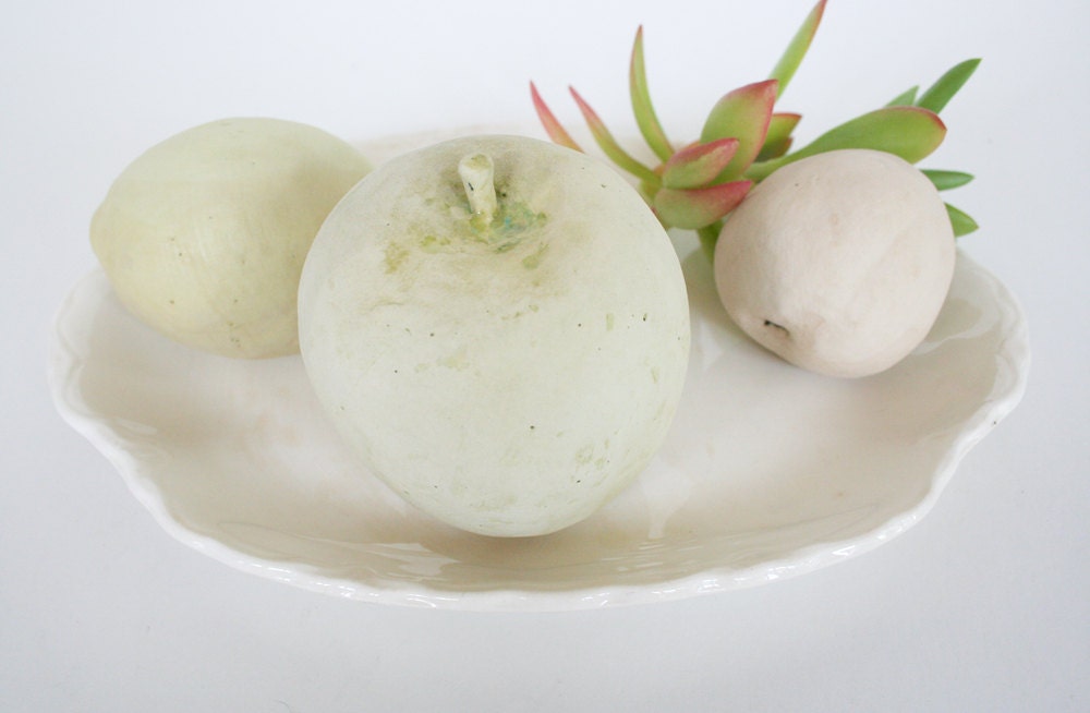 Three hand built earthenware fruit: apple, lemon, peach.