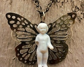 Authentic One Inch Tall Frozen Charlotte Doll on a Springtime Antique Brass Butterfly Pendant Necklace