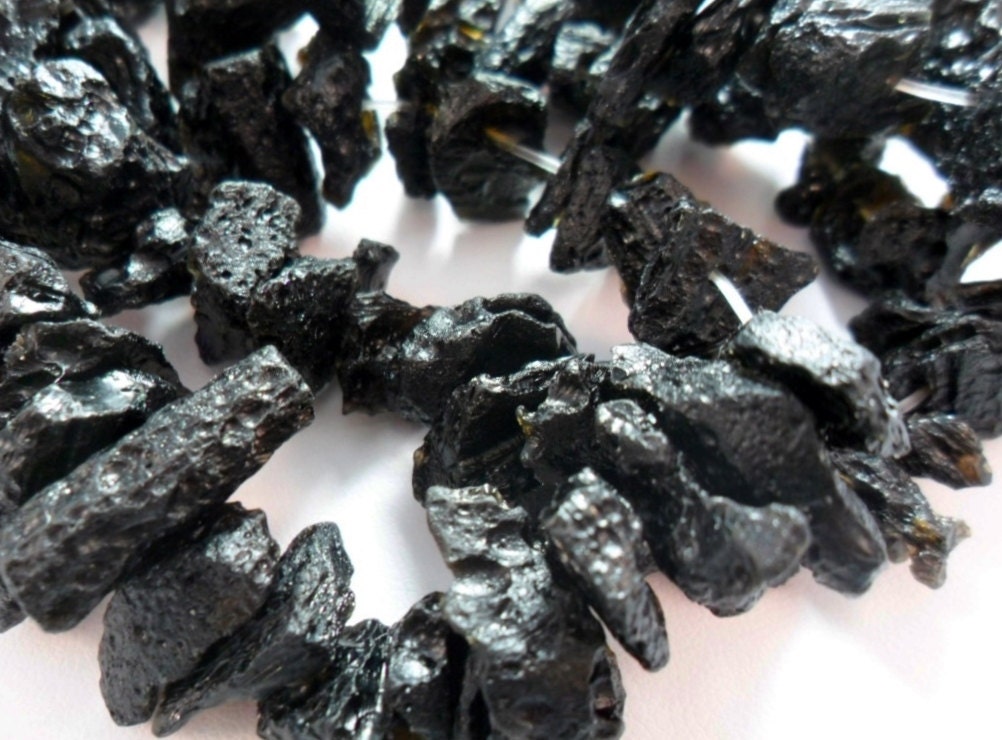 Gemstone, tektite, Rough, black stone drilled beads, graduated Strand. 8 inch strand, 10 to12mm x 5-10mm