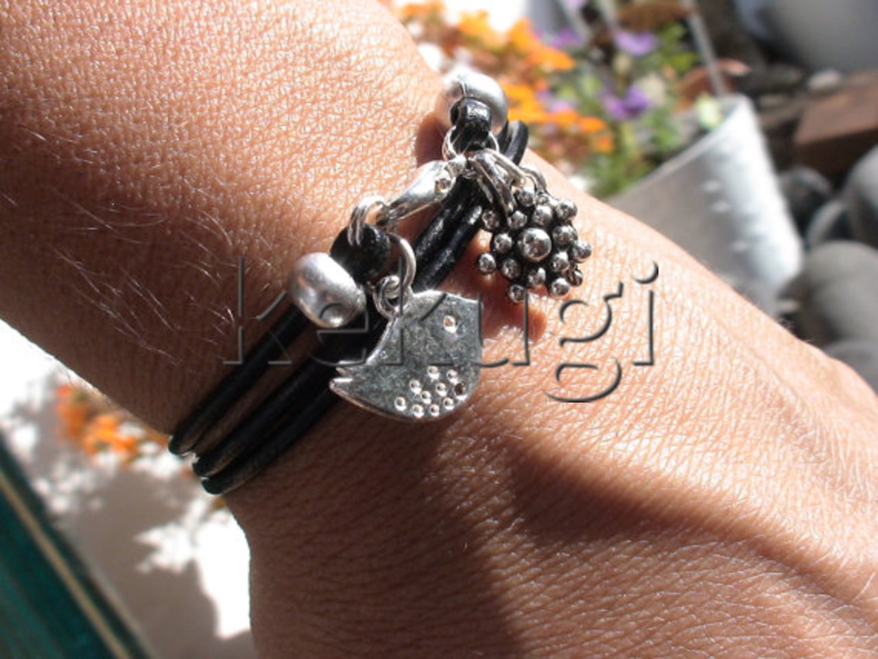 Multi wrap leather bracelet with a flower, bird and leaf drop charms