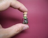 Tiny angler is fishing in the river in a tiny bottle