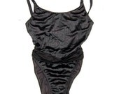 Belted black one piece suit with bow 1980s