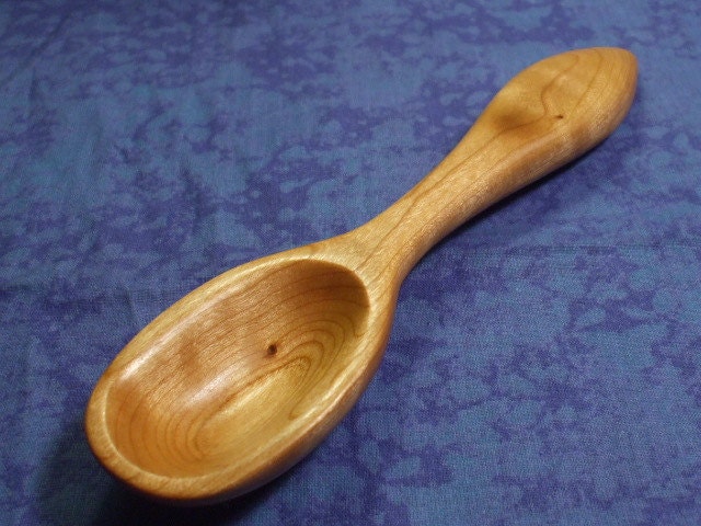 Hand carved rustic eating spoon in curly cherry wood
