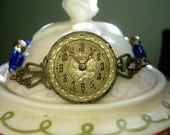 Time Flies...Steampunk Assemblage bracelet with vintage watch face Cobalt glass beads and brass findings