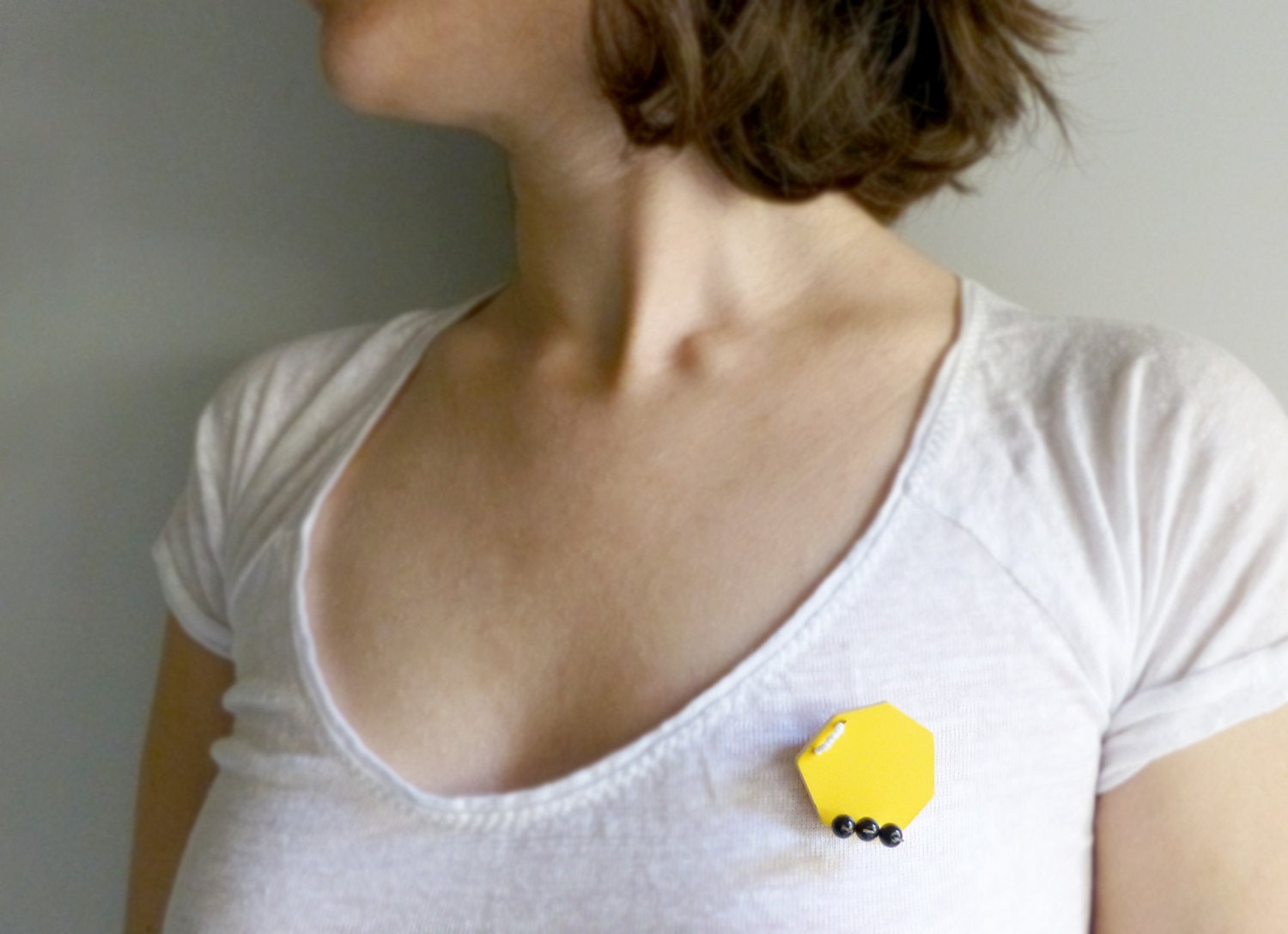 geometric minimal yellow polygonal brooch with three black dots - contemporary jewelry