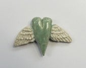 Handmade winged heart bead.