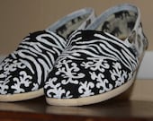 Handpainted Toms... personalized for your special occassion. Zebra stripes, flowers, scroll work, black and white canvas shoes