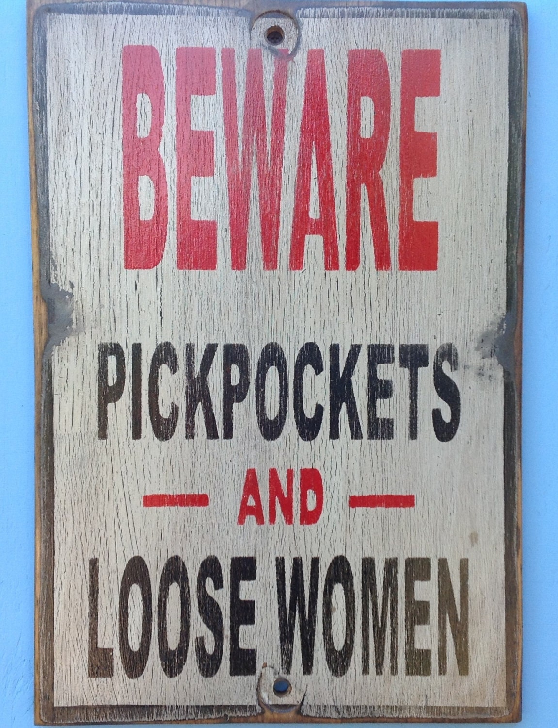 Beware pickpockets and loose women sign made from reclaimed plywood