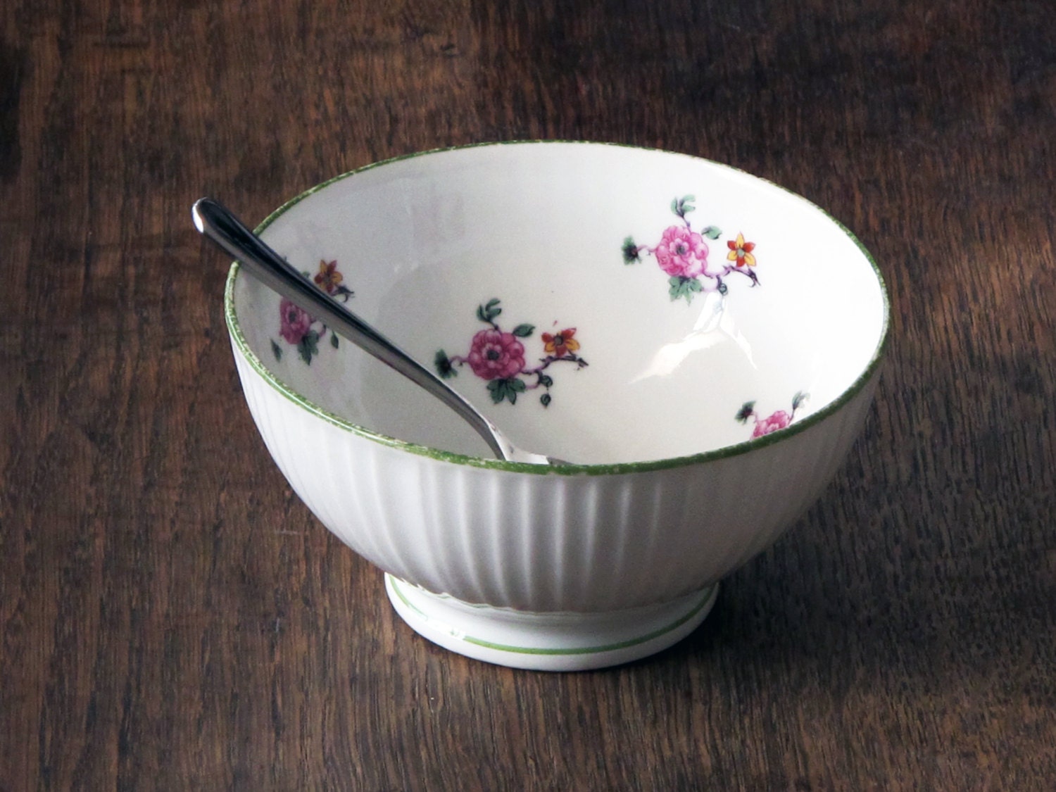 antique french cafe au lait bowl , fine porcelain,  white faceted, country flowers pattern inside