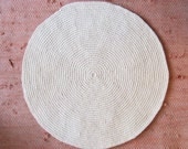 small off-white round wool rug mat