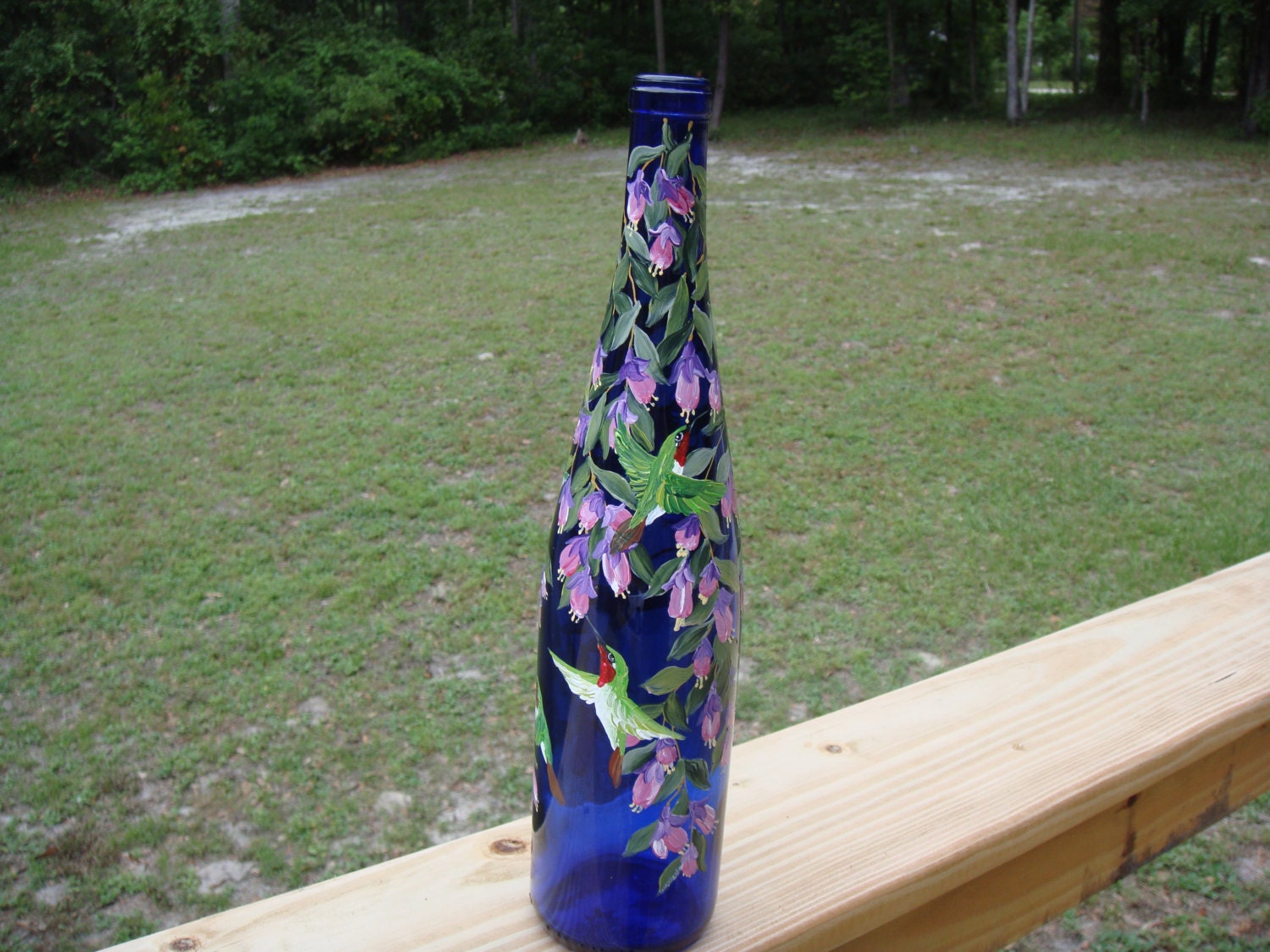 Hand painted cobalt blue wine bottle with hummingbirds