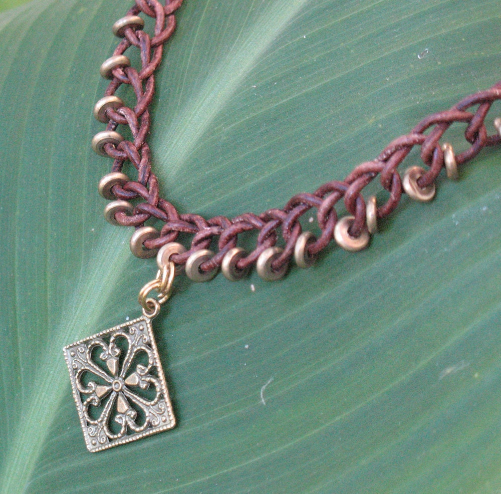 Red-brown leather braided necklace with copper beads and pendant