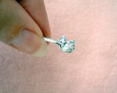 Tiny grey kitten on a miniature dollhouse spoon