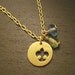 Be kind. Handmade brass bird motif logo necklace with blue and green beads