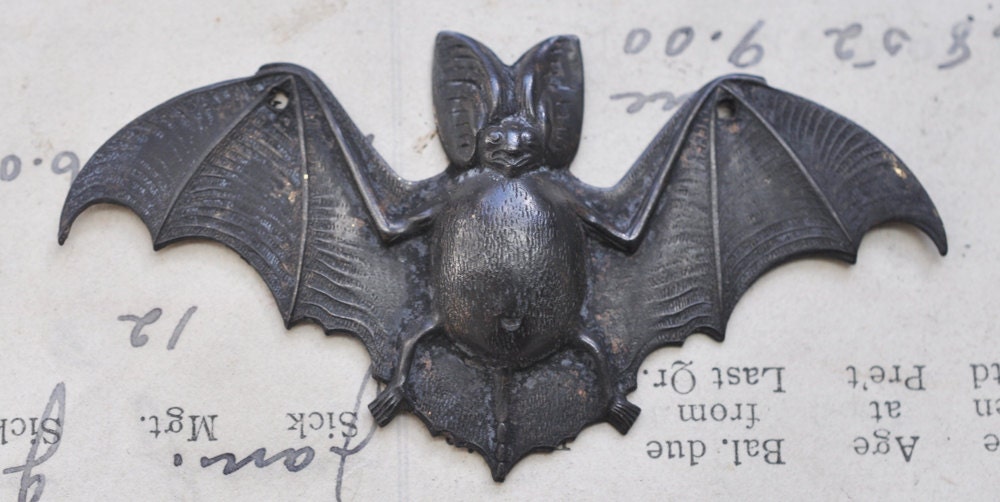 Drilled bat brass stamping, black patina