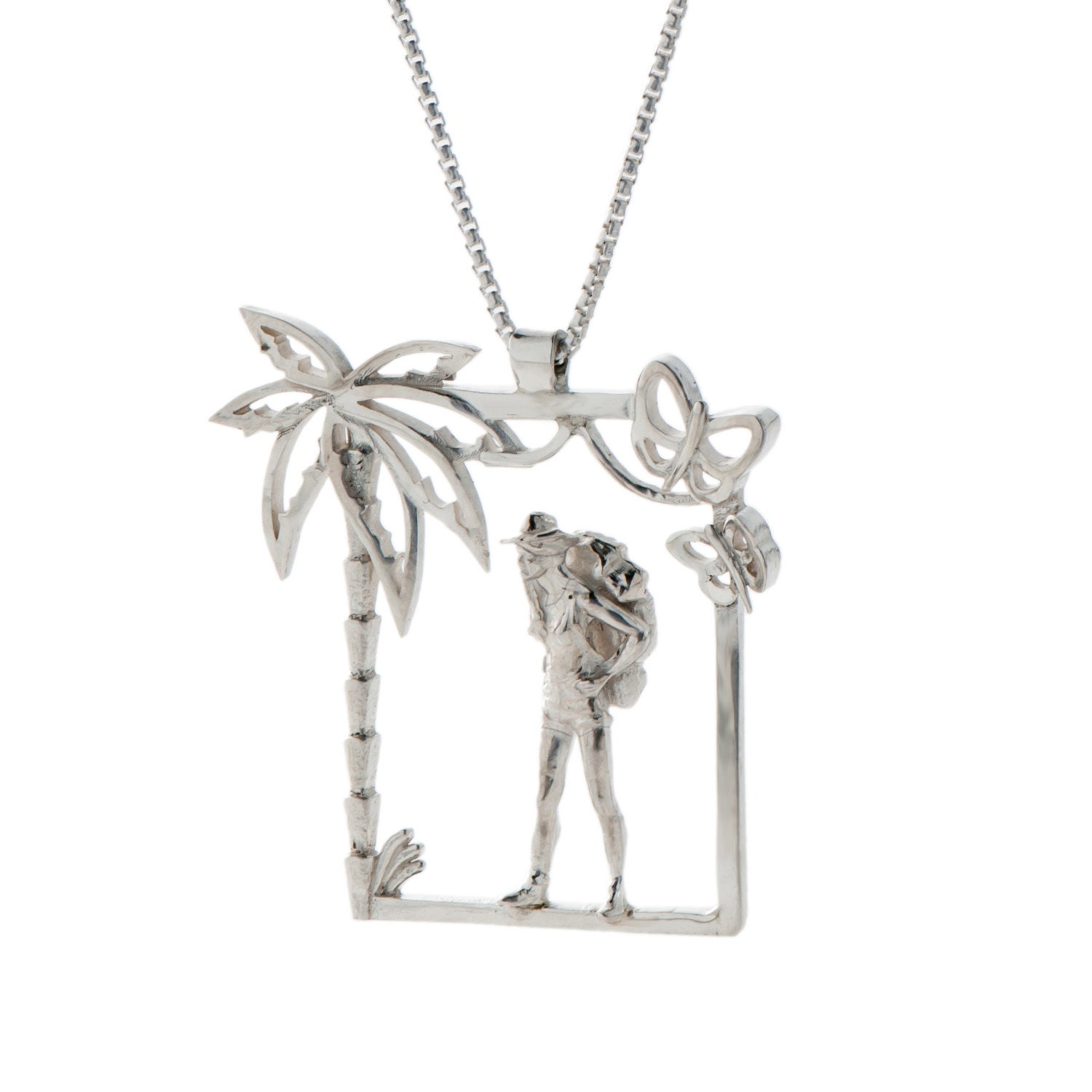 Silver Pendant of a woman with a bag on her back and surrounded by the magical nature.