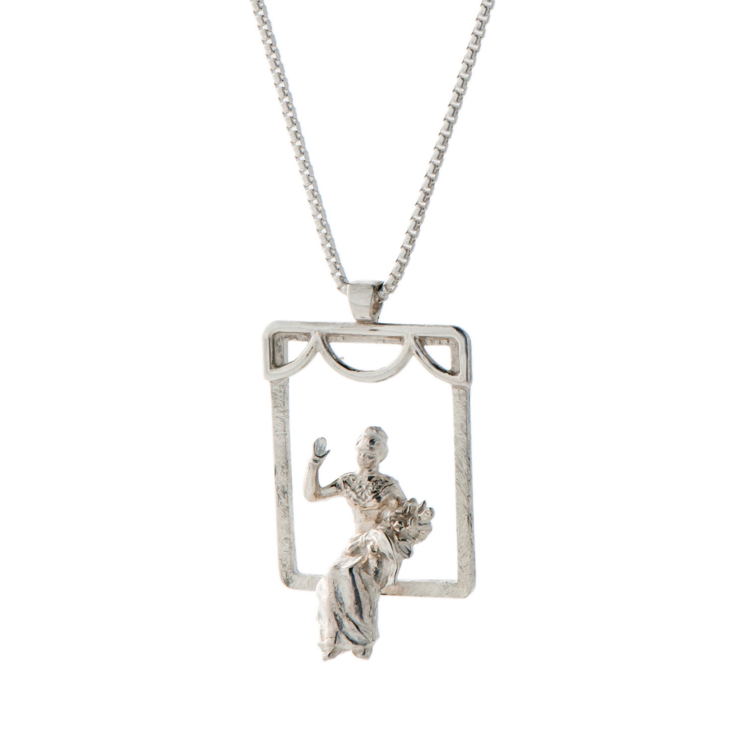 Sterling Silver pendant of A beautiful and successful woman, holding a bouquet of flowers in one hand and waving with the other hand.