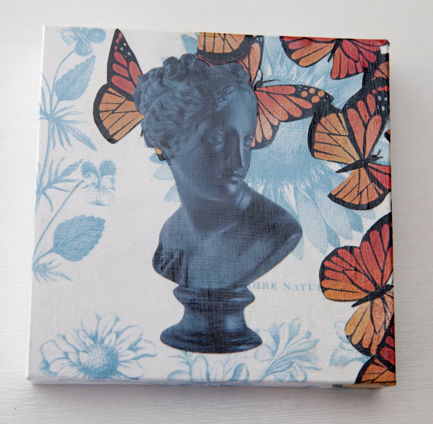 Bust collage on wood block