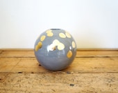 gray and gold spherical bud vase