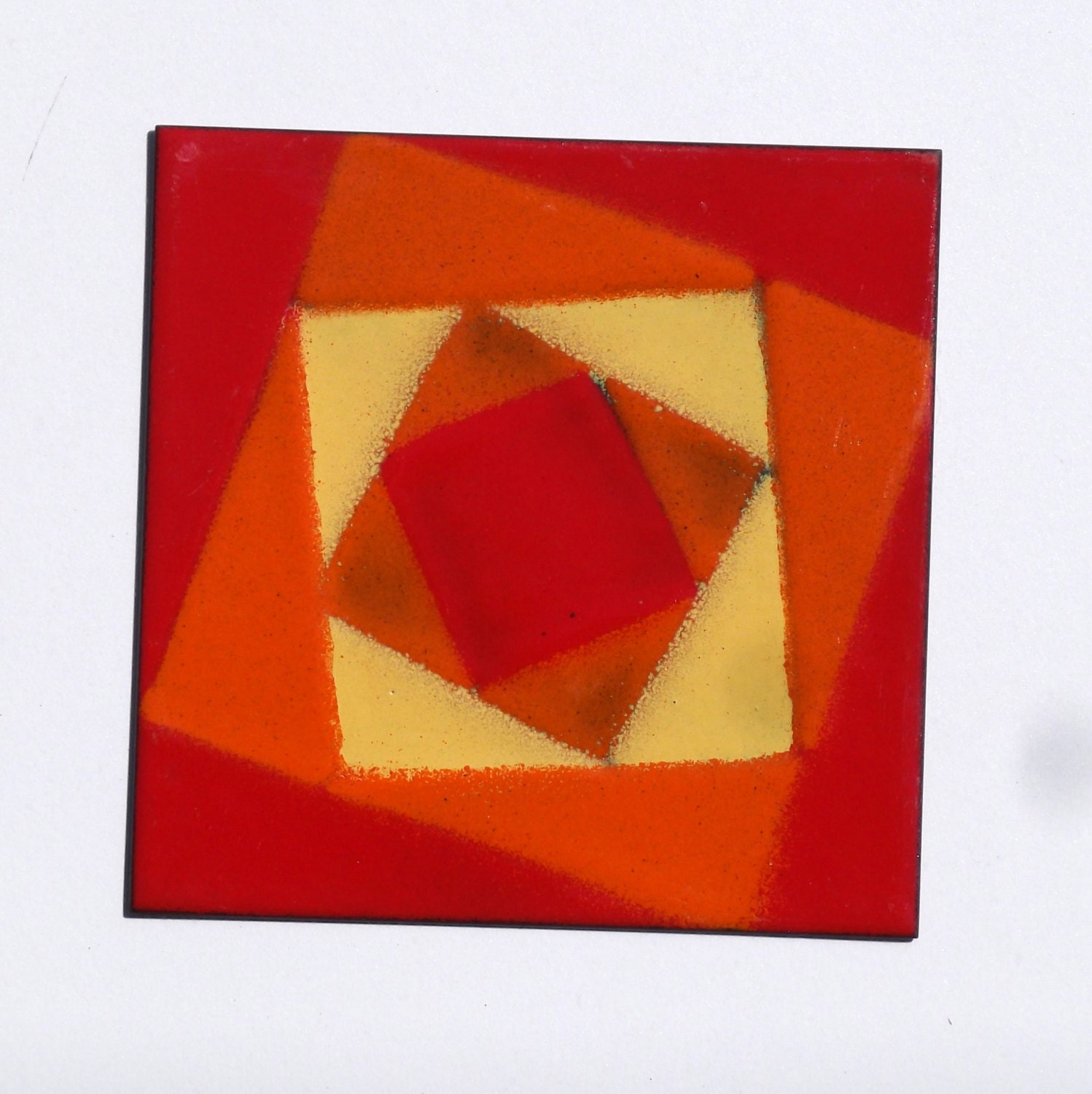 Mod enameled copper tile in bright red, yellow and orange