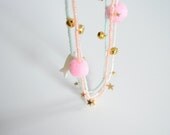 Star and pompom necklace in orange