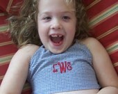 Girl's swimsuit in navy check seersucker with skirted bottoms