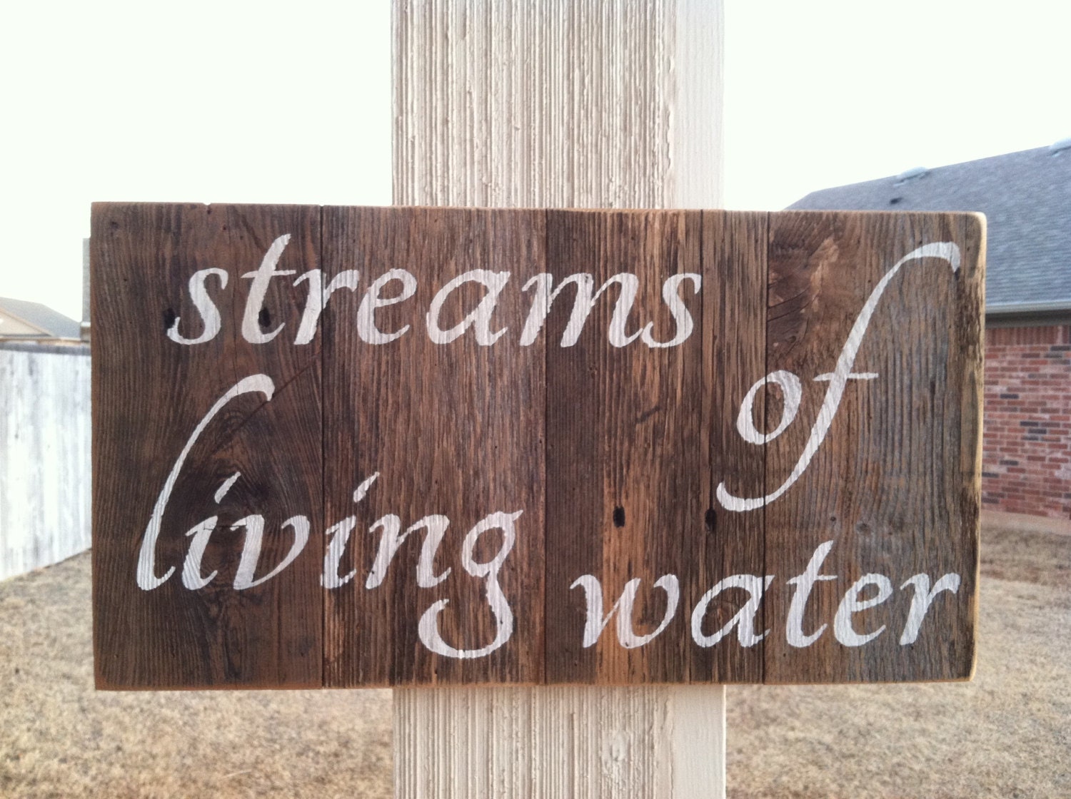 Streams Of Living Water painted in white on a handmade rustic cedar fence picket sign