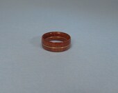 size 9 ring made from Purpleheart wood with a band of copper in the middle