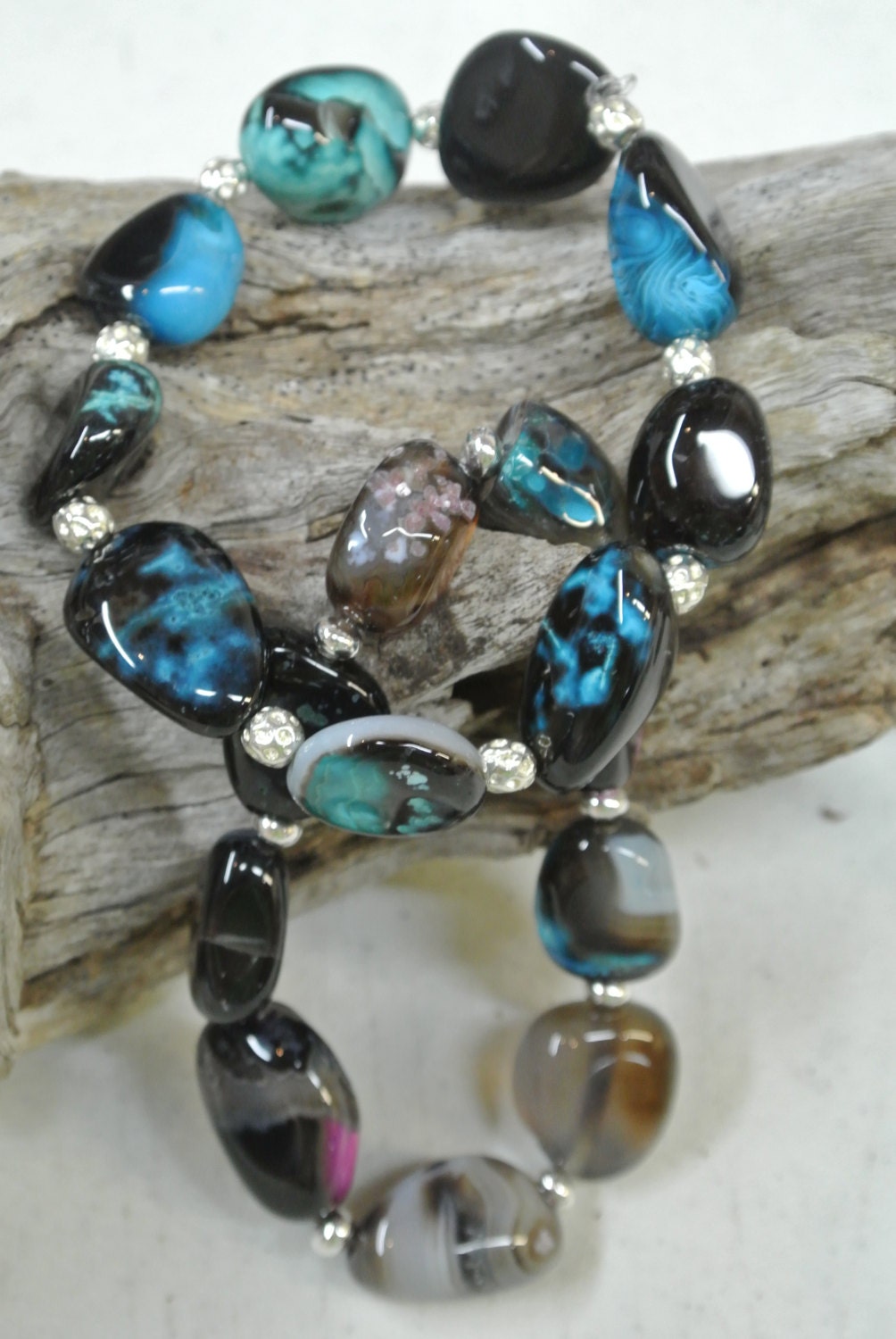 Elastic cord custom jewelry beaded bracelet with Natural Rainbow Agate stones and sterling silver spacers.