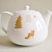 Teapot with fox and trees