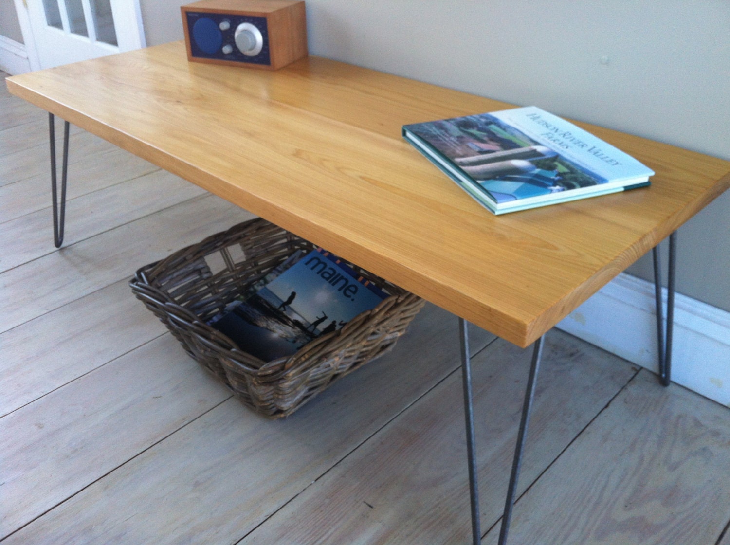 Modern industrial/mid century modern wood & steel coffee table featuring cypress top with hairpin legs.
