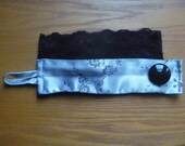 fabric wrist cuff, silver satin with black lace and button
